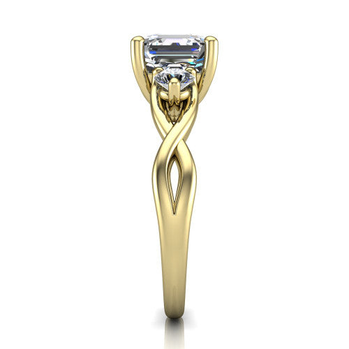 Lydia square emerald three stone engagement ring in 18K Yellow Gold, side profile showing the round side diamonds, floral gallery, and woven infinity shank