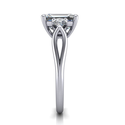 Journee emerald three stone engagement ring in Platinum, side profile showing the split-V gallery, tapered cathedral shoulders, and polished band