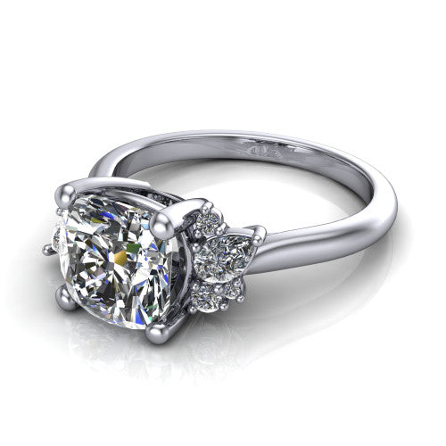 Evie cushion three stone engagement ring in 18K White Gold, three-quarter perspective showing the cathedral rise and accent clusters fanning out on both sides of the center