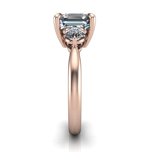 Juniper square emerald three stone engagement ring in 14K Rose Gold, side profile showing the three-stone head and slim rounded polished band