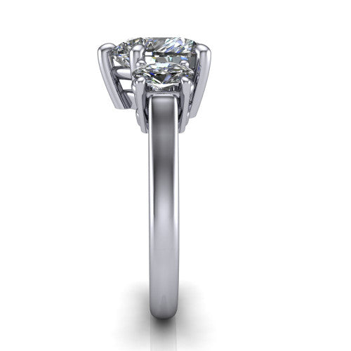 Imogen heart three stone engagement ring in Platinum, side profile showing the round side stone and the smooth tapered polished band