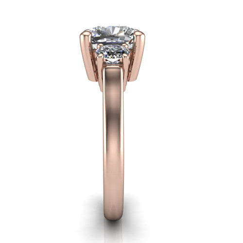 Imogen cushion three stone engagement ring in 18K Rose Gold, side profile showing the round side stone and the smooth tapered polished band
