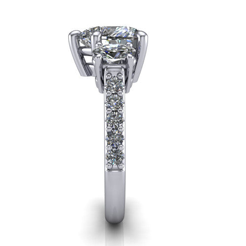 Poppy heart three stone engagement ring in 14K White Gold, side profile showing the round side stone and the pavé diamonds running down the shank