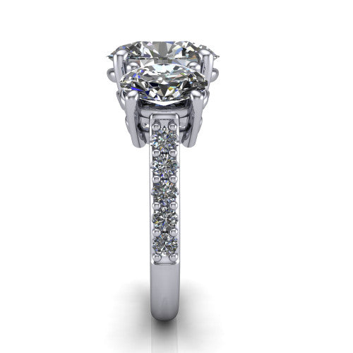 Poppy oval three stone engagement ring in 18K White Gold, side profile showing the round side stone and the pavé diamonds running down the shank