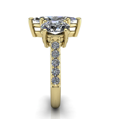 Poppy marquise three stone engagement ring in 18K Yellow Gold, side profile showing the round side stone and the pavé diamonds running down the shank