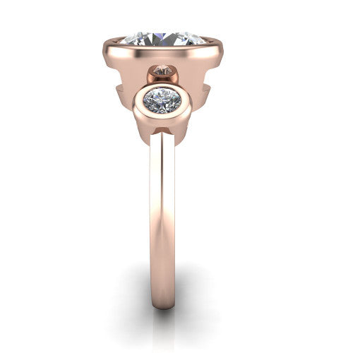 Daisy round three stone engagement ring in 18K Rose Gold, side profile showing the bezel-set round side stone and the smooth polished band