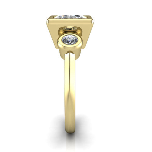 Daisy princess three stone engagement ring in 18K Yellow Gold, side profile showing the bezel-set round side stone and the smooth polished band