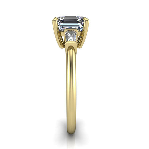 Jade asscher three stone engagement ring in 18K Yellow Gold with tapered baguette side stones, side profile showing the plain band and bar-set baguette