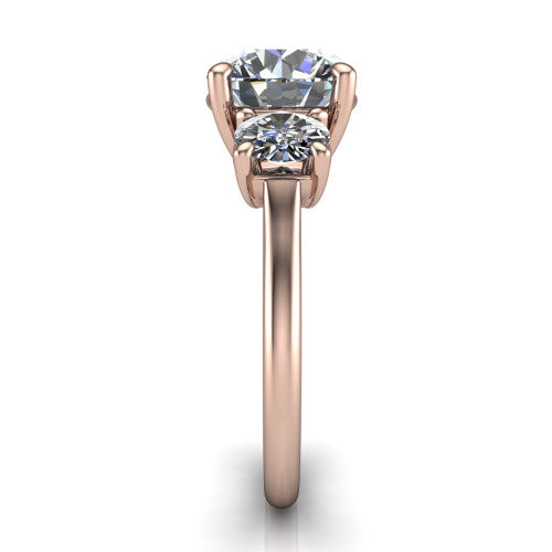 Emma round three stone engagement ring in 14K Rose Gold, side profile showing the round side stone and the smooth tapered polished band