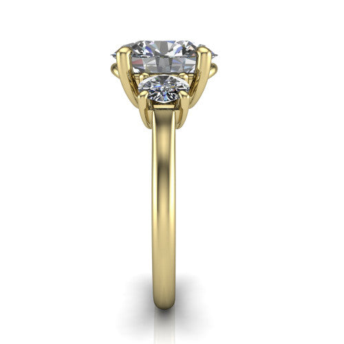 Emma oval three stone engagement ring in 14K Yellow Gold, side profile showing the round side stone and the smooth tapered polished band