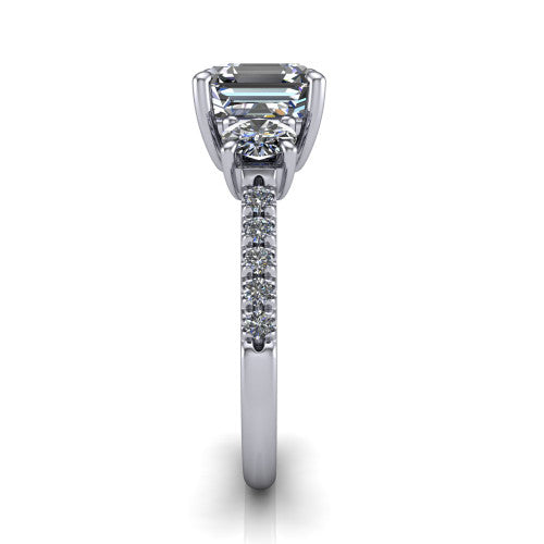 Celeste asscher three stone engagement ring in 18K White Gold, side profile showing the round side stone and the pavé diamonds running down the shank