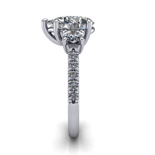 Celeste pear three stone engagement ring in 14K White Gold, side profile showing the round side stone and the pavé diamonds running down the shank