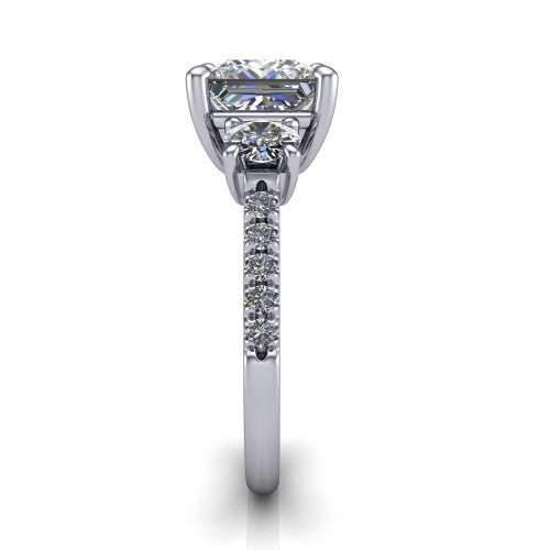 Celeste princess three stone engagement ring in 18K White Gold, side profile showing the round side stone and the pavé diamonds running down the shank