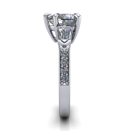 Audrey heart three stone engagement ring in 14K White Gold, side profile showing the tapered baguette side stone and the round diamonds running down the shank