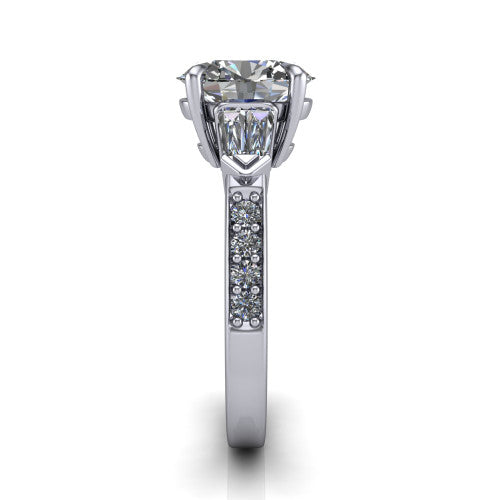 Audrey oval three stone engagement ring in 18K White Gold, side profile showing the tapered baguette side stone and the round diamonds running down the shank