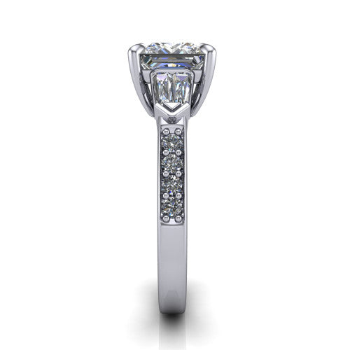Audrey princess three stone engagement ring in 14K White Gold, side profile showing the tapered baguette side stone and the round diamonds running down the shank