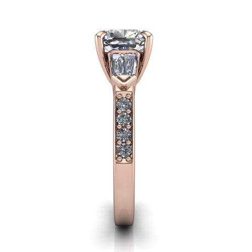 Audrey cushion three stone engagement ring in 14K Rose Gold, side profile showing the tapered baguette side stone and the round diamonds running down the shank