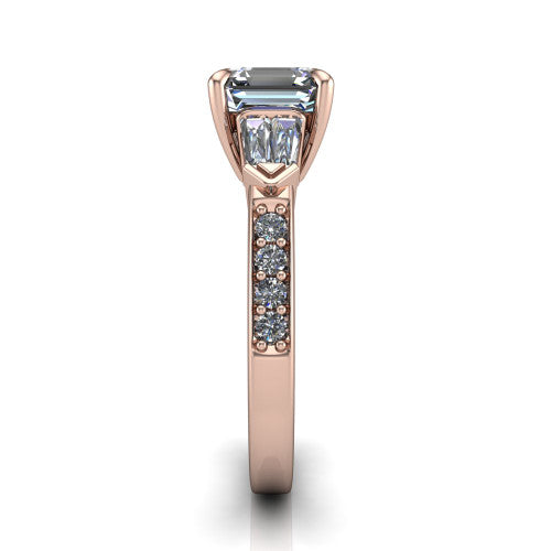 Audrey asscher three stone engagement ring in 14K Rose Gold, side profile showing the tapered baguette side stone and the round diamonds running down the shank