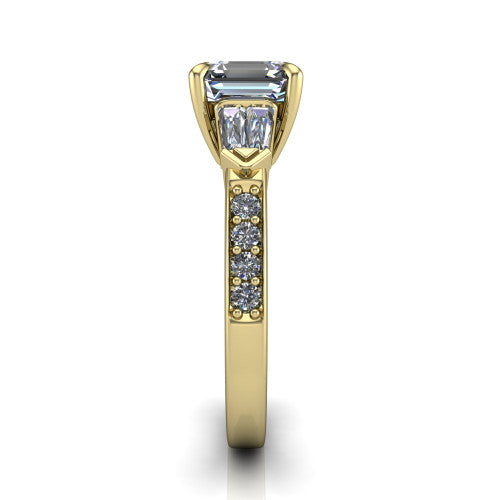 Audrey asscher three stone engagement ring in 14K Yellow Gold, side profile showing the tapered baguette side stone and the round diamonds running down the shank