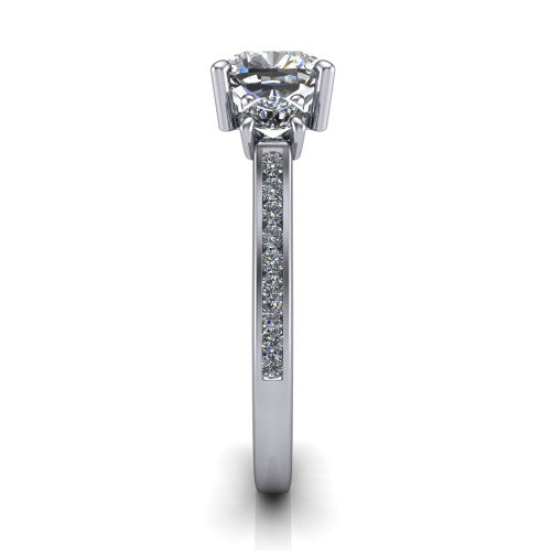 Saoirse cushion three stone engagement ring in Platinum, side profile showing the round side stone and the pavé diamonds running down the shank