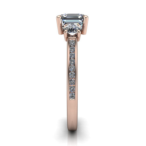 Saoirse asscher three stone engagement ring in 14K Rose Gold, side profile showing the round side stone and the pavé diamonds running down the shank