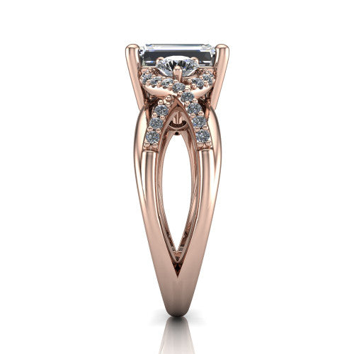 Amara emerald three stone engagement ring in 14K Rose Gold, side profile showing the pavé rails crossing in an infinity twist beneath the head