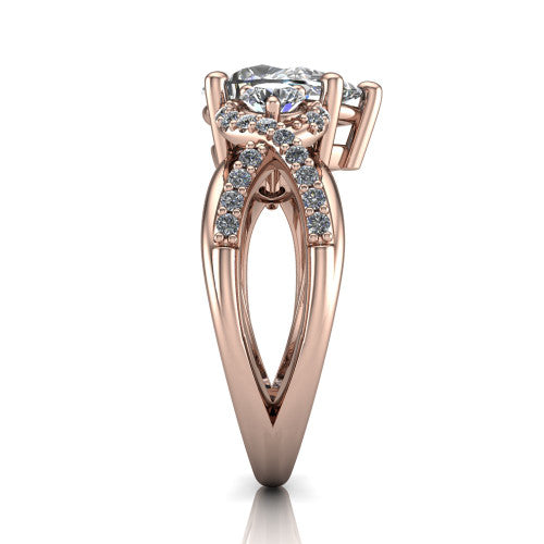 Amara pear three stone engagement ring in 14K Rose Gold, side profile showing the pavé rails crossing in an infinity twist beneath the head