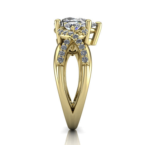 Amara pear three stone engagement ring in 18K Yellow Gold, side profile showing the pavé rails crossing in an infinity twist beneath the head