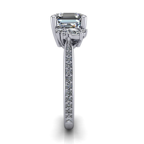 Mila asscher three stone engagement ring in Platinum, side profile showing the round accent cluster and the pavé diamonds running down the shank