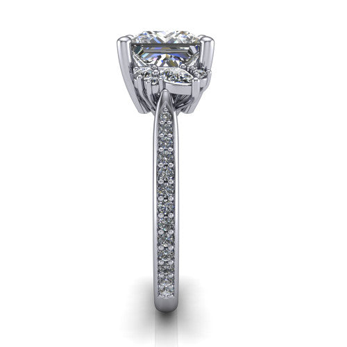 Mila princess three stone engagement ring in 14K White Gold, side profile showing the round accent cluster and the pavé diamonds running down the shank