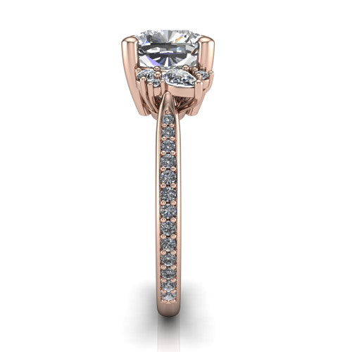 Mila cushion three stone engagement ring in 14K Rose Gold, side profile showing the round accent cluster and the pavé diamonds running down the shank