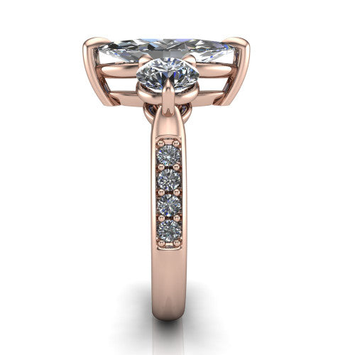 Blake marquise three stone engagement ring in 18K Rose Gold, side profile showing the round side stone and the pavé diamonds running down the shank