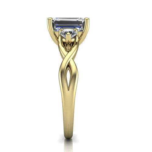 Alina emerald three stone engagement ring in 18K Yellow Gold, side profile showing the twisted infinity vine band sweeping to the emerald center