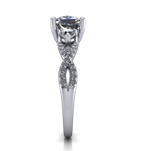 Ryleigh cushion three stone engagement ring in Platinum, side profile showing the twisted pavé infinity band sweeping to the cushion center