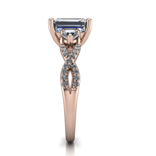 Ryleigh emerald three stone engagement ring in 14K Rose Gold, side profile showing the twisted pavé infinity band sweeping to the emerald center