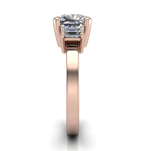 Madelyn cushion three stone engagement ring in 14K Rose Gold with emerald-cut side stones, side profile showing the plain band and step-cut side stones
