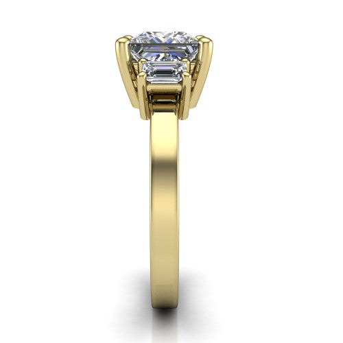 Madelyn princess three stone engagement ring in 18K Yellow Gold with emerald-cut side stones, side profile showing the plain band and step-cut side stones
