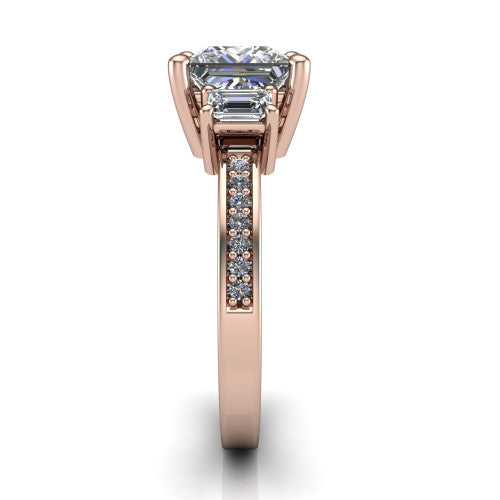 Freya princess three stone engagement ring in 18K Rose Gold, side profile showing the pavé milgrain band and the three-stone setting in profile