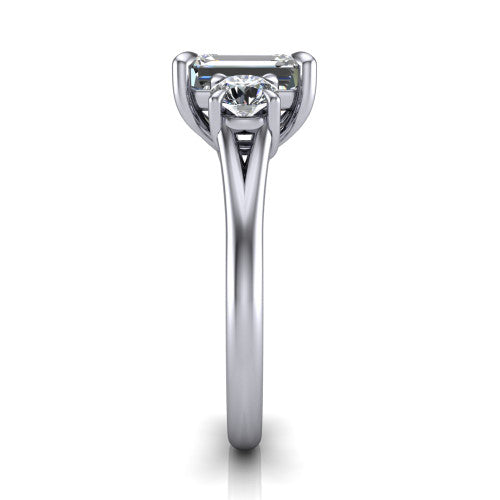 Jasmine emerald three stone engagement ring in Platinum with round side stones, side profile showing the plain band and split under-gallery