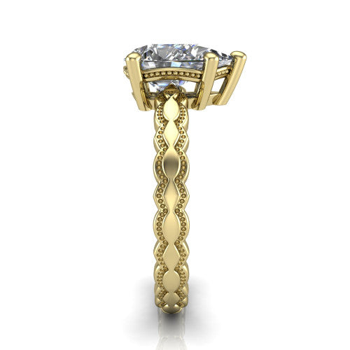 Flora pear solitaire engagement ring in 18K Yellow Gold, side profile showing the scalloped milgrain band and the open basket beneath the pear center