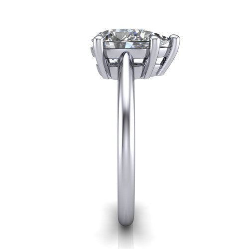 Avery pear classic solitaire engagement ring in Platinum, side profile showing the smooth polished band and the open basket beneath the pear center