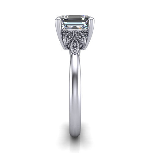 Athena square emerald vintage solitaire engagement ring in Platinum, side profile showing the fleur-de-lis filigree accents, milgrain detail, and plain band in profile