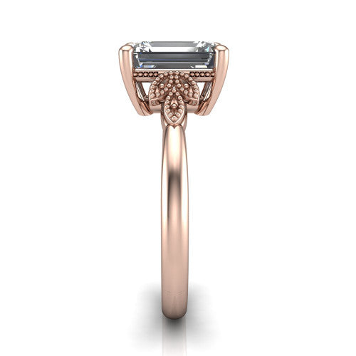 Athena emerald vintage solitaire engagement ring in 18K Rose Gold, side profile showing the fleur-de-lis filigree accents, milgrain detail, and plain band in profile