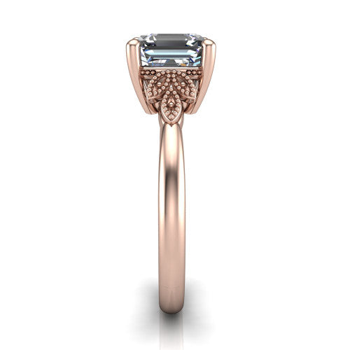 Athena square emerald vintage solitaire engagement ring in 18K Rose Gold, side profile showing the fleur-de-lis filigree accents, milgrain detail, and plain band in profile