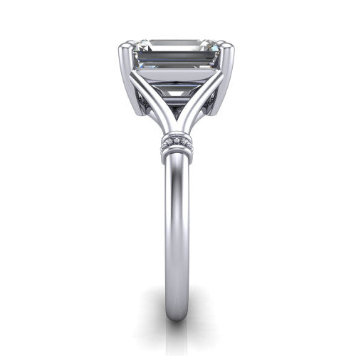 Luna emerald classic solitaire engagement ring in Platinum, side profile showing the plain split shank with pavé accent collars rising to the emerald center