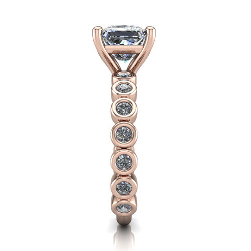 Kinsley princess solitaire engagement ring in 18K Rose Gold with bezel-set diamond accent band, side profile showing the bezel-set diamond shank