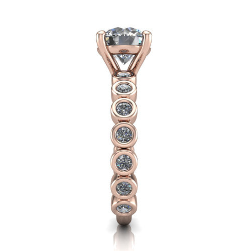 Kinsley round solitaire engagement ring in 18K Rose Gold with bezel-set diamond accent band, side profile showing the bezel-set diamond shank
