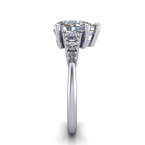 Emery pear accent engagement ring in Platinum with graduated round side stones, side profile showing the graduated side stones and plain band