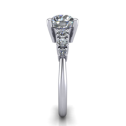 Emery round accent engagement ring in Platinum with graduated round side stones, side profile showing the graduated side stones and plain band