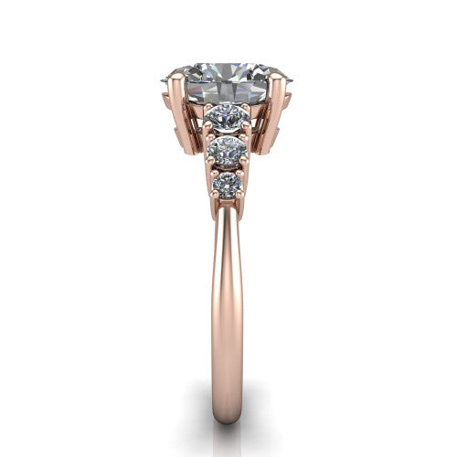 Emery oval accent engagement ring in 14K Rose Gold with graduated round side stones, side profile showing the graduated side stones and plain band
